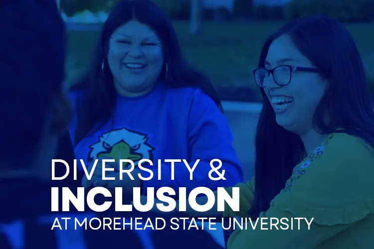 two Latina female students at a table talking with text Diversity & Inclusion at Morehead State University