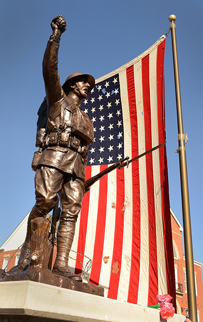 American flag and Doughboy statue
